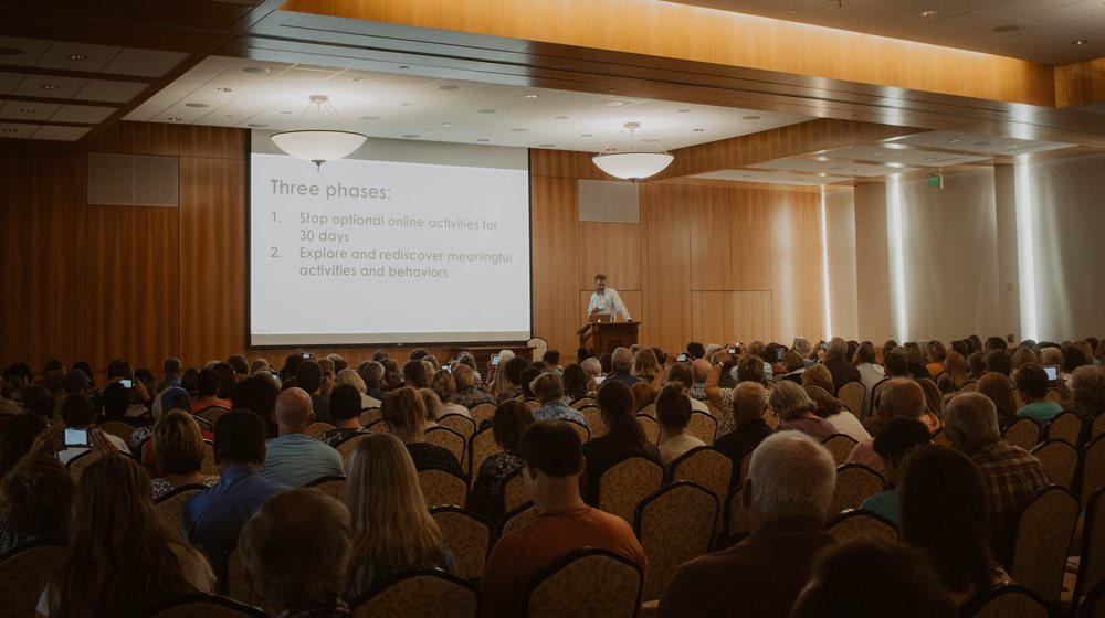 A full hall of attendees, Matt Morgan presenting at the podium